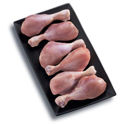 On a rectangular black plate, against a white background, six chicken leg drumsticks from the Chicken leg drumstick 1 kg pack are neatly arranged. Smart Chicken